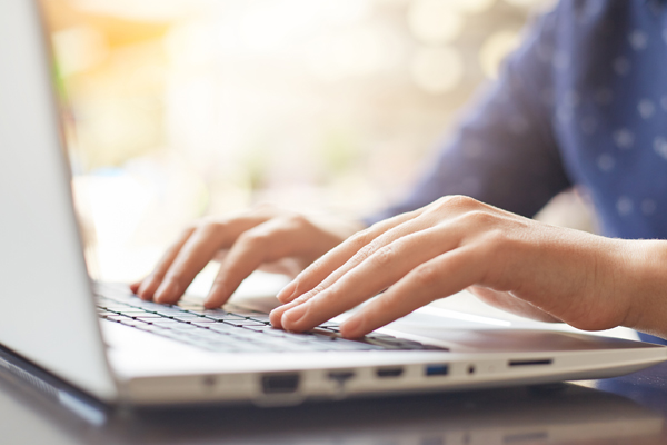 person typing on laptop